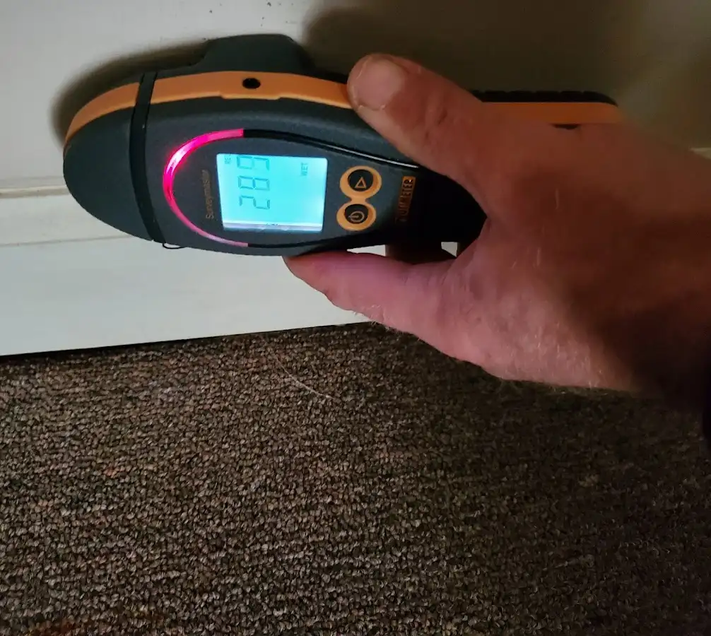 Moisture detection at baseboard during Storm Damage Restoration in Brownwood